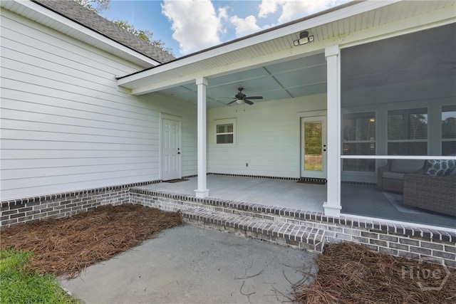 entrance to property with a ceiling fan and a patio