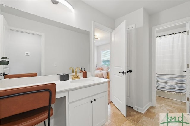 1546 Wilkins Rd, Midway, GA 31320 - bathroom with vanity, connected bathroom, and baseboards