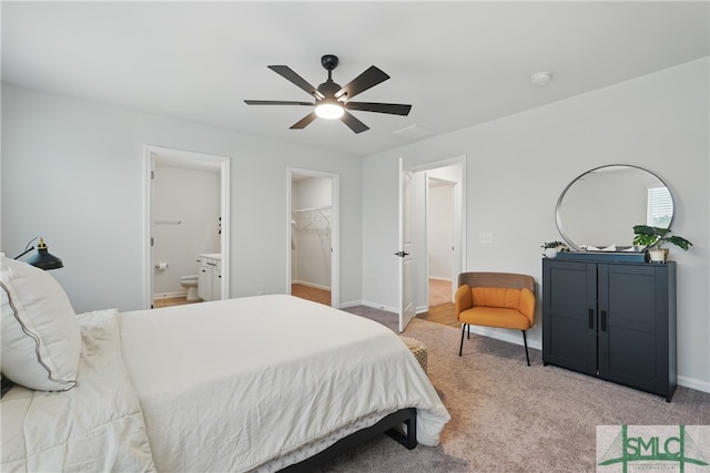 1546 Wilkins Rd, Midway, GA 31320 - bedroom with light colored carpet, ensuite bathroom, a walk in closet, and baseboards