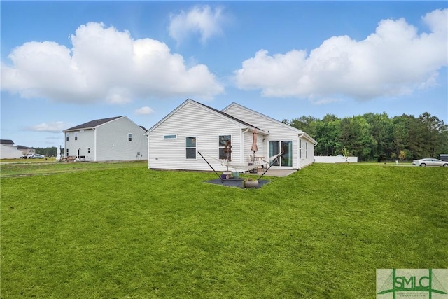 1546 Wilkins Rd, Midway, GA 31320 - back of house featuring a lawn and a patio