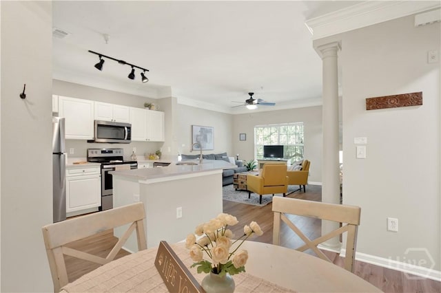 3021 Whitemarsh Way, Savannah, GA 31410 - dining room with a ceiling fan, light wood finished floors, track lighting, crown molding, and baseboards