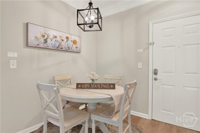 3021 Whitemarsh Way, Savannah, GA 31410 - dining area with a chandelier, baseboards, wood finished floors, and ornamental molding