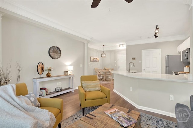 3021 Whitemarsh Way, Savannah, GA 31410 - living area with wood finished floors, ceiling fan, ornamental molding, and baseboards