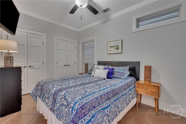 5 17th St, Tybee Island, GA 31328 - bedroom with light tile patterned flooring, crown molding, two closets, a ceiling fan, and baseboards