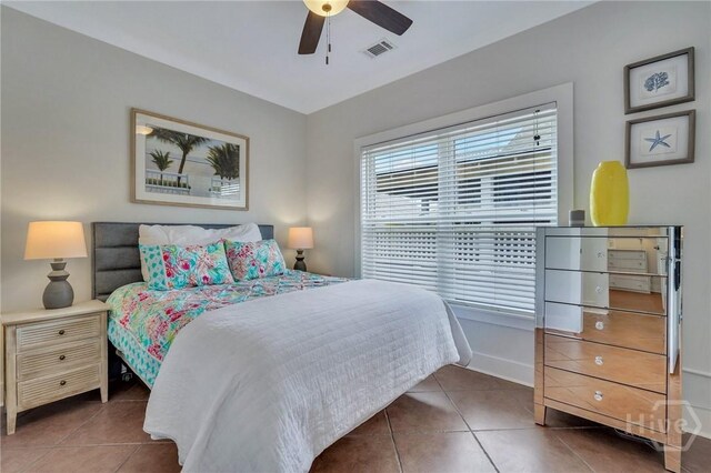 5 17th St, Tybee Island, GA 31328 - tiled bedroom featuring a ceiling fan and baseboards
