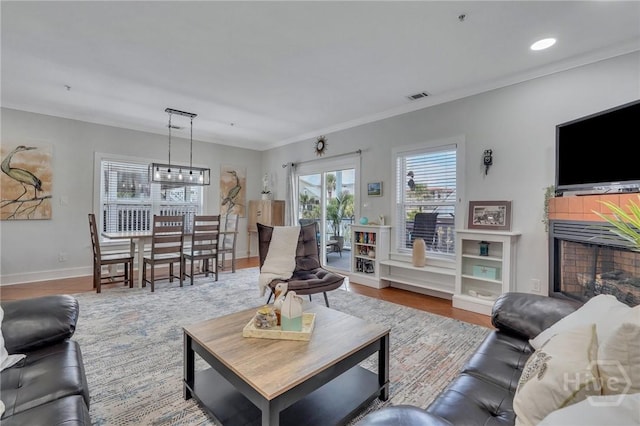 5 17th St, Tybee Island, GA 31328 - living area with baseboards, wood finished floors, ornamental molding, and recessed lighting