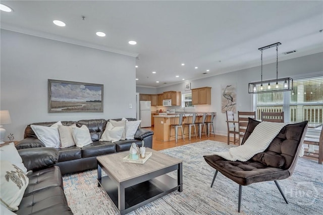 5 17th St, Tybee Island, GA 31328 - living area with recessed lighting, crown molding, baseboards, and light wood-style floors