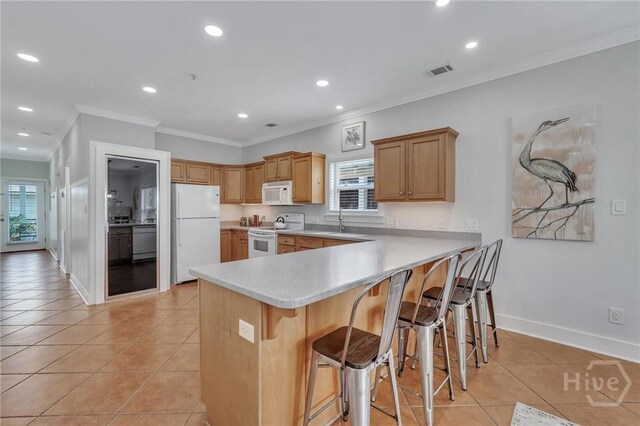 5 17th St, Tybee Island, GA 31328 - kitchen featuring white appliances, ornamental molding, a peninsula, healthy amount of natural light, and light tile patterned floors