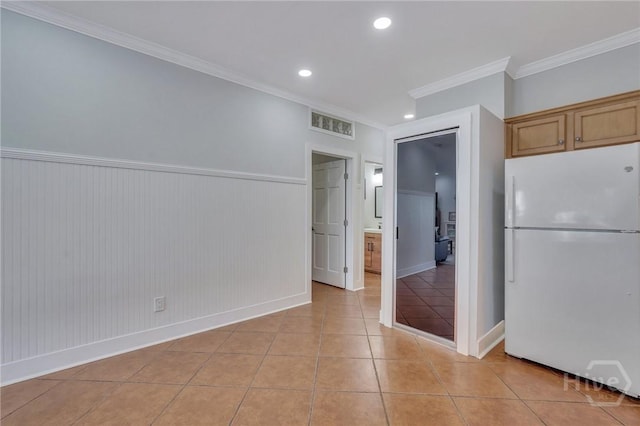 5 17th St, Tybee Island, GA 31328 - unfurnished dining area with ornamental molding, light tile patterned floors, a wainscoted wall, baseboards, and recessed lighting