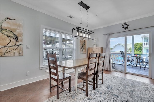 5 17th St, Tybee Island, GA 31328 - dining space featuring tile patterned flooring, crown molding, baseboards, and a chandelier
