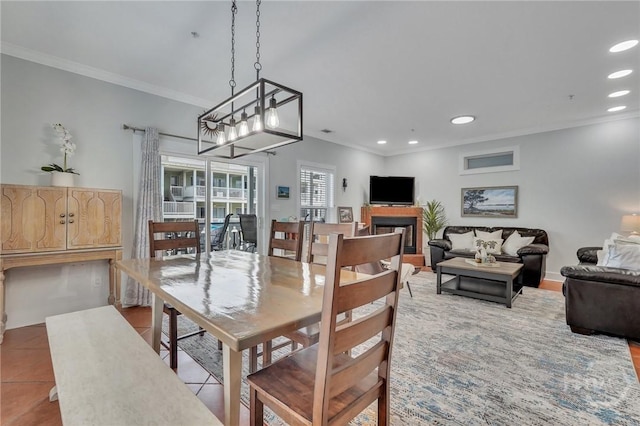 5 17th St, Tybee Island, GA 31328 - dining room with ornamental molding, recessed lighting, tile patterned flooring, a fireplace, and a chandelier