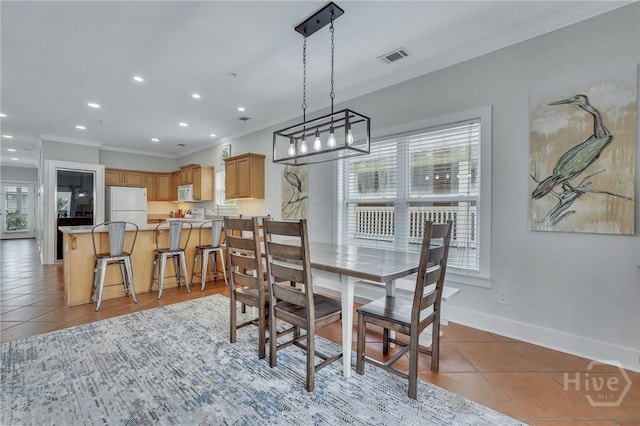 5 17th St, Tybee Island, GA 31328 - dining room with crown molding, light tile patterned floors, baseboards, and recessed lighting