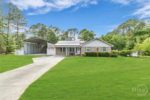 ranch-style home featuring a detached carport, concrete driveway, roof mounted solar panels, and brick siding