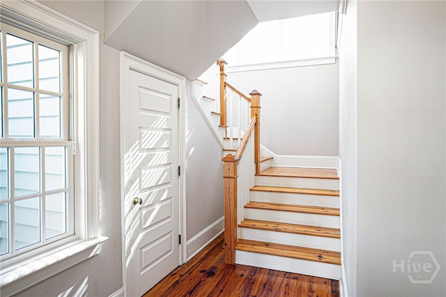stairway featuring wood finished floors and baseboards