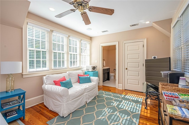 living area with wood finished floors, baseboards, a ceiling fan, and recessed lighting