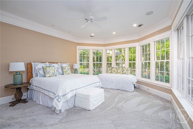 carpeted bedroom featuring crown molding, multiple windows, baseboards, and ceiling fan