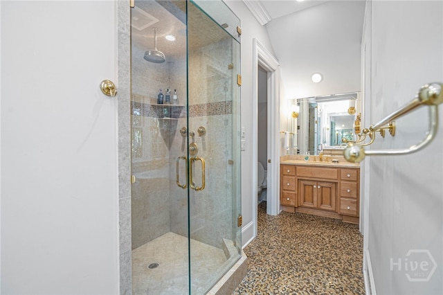 full bath featuring a shower stall, vanity, and baseboards