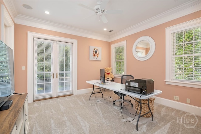 office space with crown molding, light carpet, baseboards, and plenty of natural light