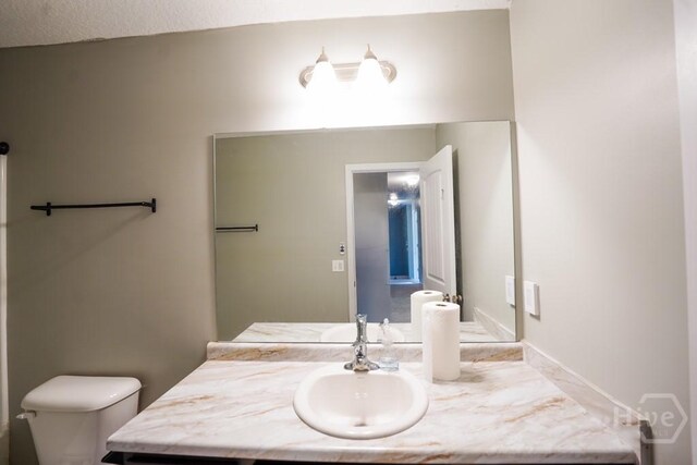 24 Daylily Ct, Hinesville, GA 31313 - half bathroom featuring vanity and toilet