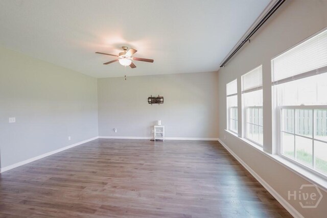 24 Daylily Ct, Hinesville, GA 31313 - empty room featuring healthy amount of natural light, ceiling fan, wood finished floors, and baseboards