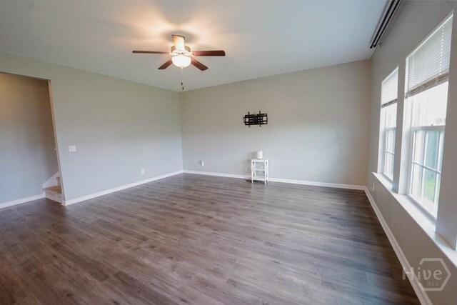 24 Daylily Ct, Hinesville, GA 31313 - unfurnished room featuring a ceiling fan, dark wood-type flooring, stairway, and baseboards