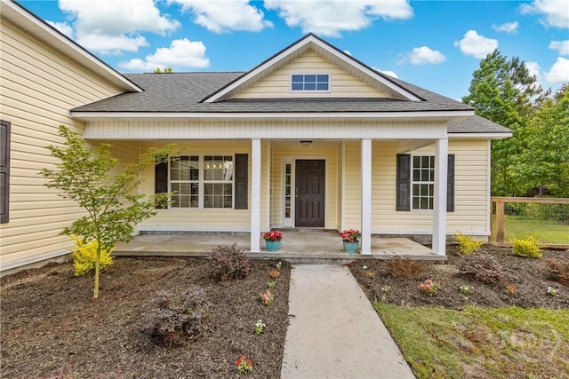 view of front of home featuring a shingled roof and a porch