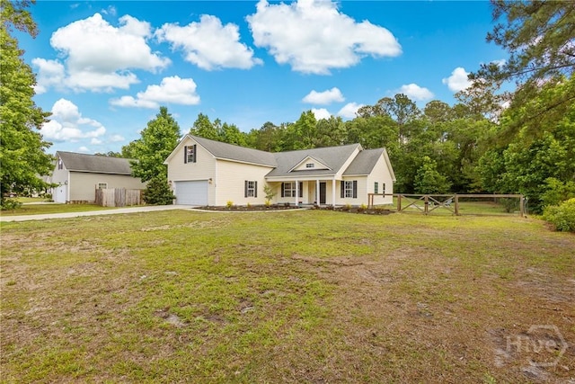 view of front facade featuring driveway, a garage, and covered porch