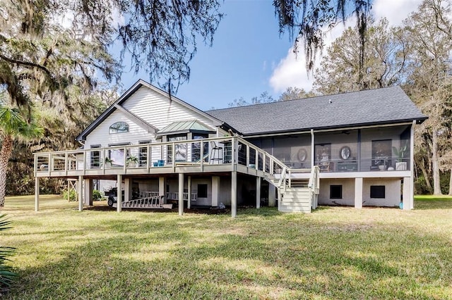back of house with a sunroom, a wooden deck, stairs, a yard, and roof with shingles