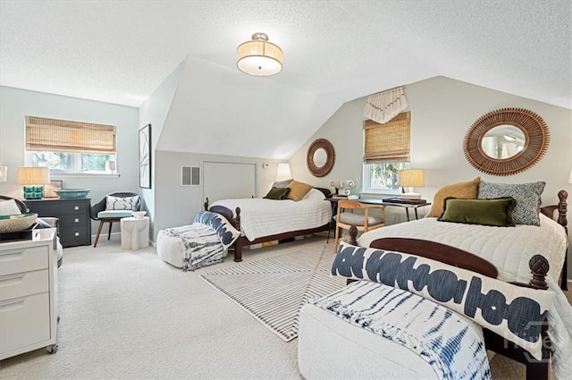 bedroom featuring multiple windows, lofted ceiling, light colored carpet, and a textured ceiling