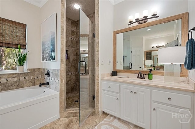 bathroom featuring crown molding, a stall shower, a garden tub, and vanity