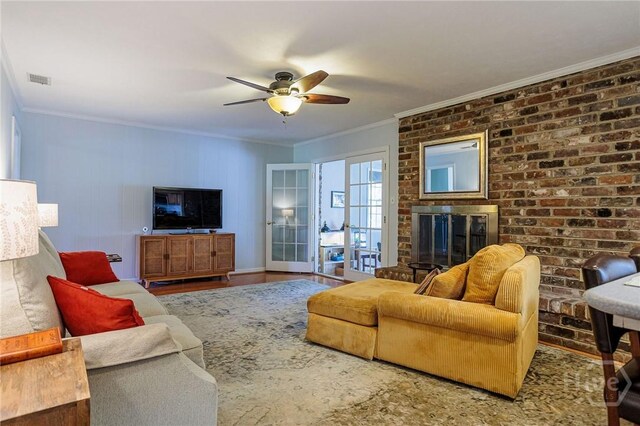 2 S Millward Rd, Savannah, GA 31410 - living room with a ceiling fan, crown molding, and a fireplace