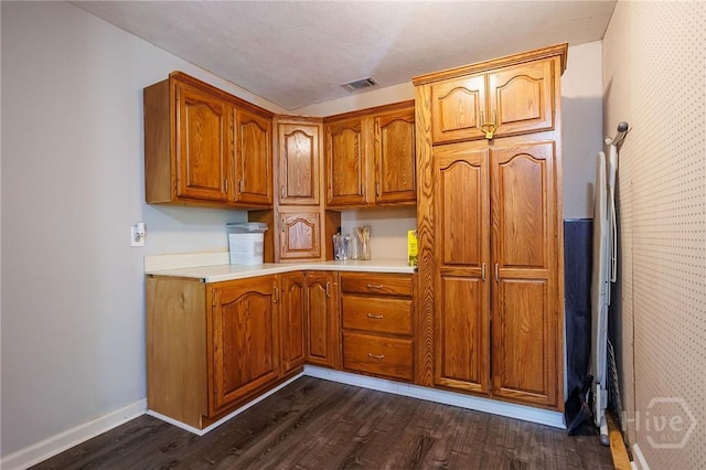 2 S Millward Rd, Savannah, GA 31410 - kitchen featuring dark wood-style floors, brown cabinetry, light countertops, and baseboards