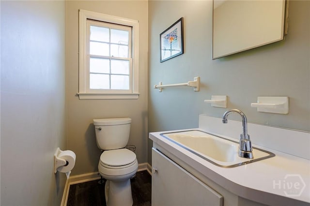 2 S Millward Rd, Savannah, GA 31410 - bathroom with baseboards, toilet, wood finished floors, and vanity