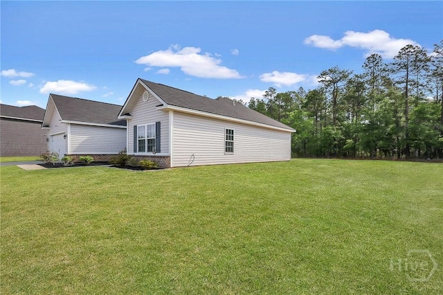 374 Bobwhite Trl NE, Ludowici, GA 31316 - view of side of property with brick siding, a garage, and a yard
