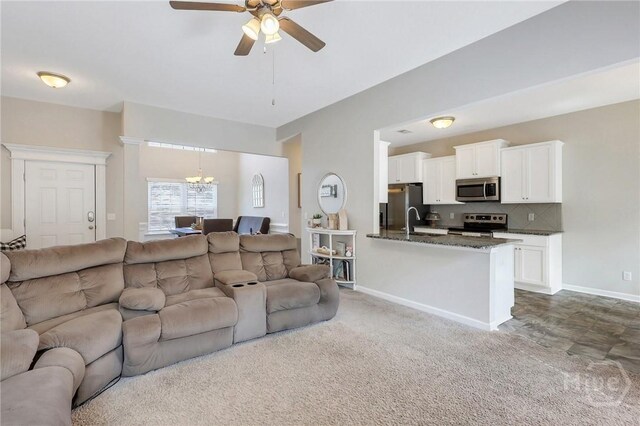 374 Bobwhite Trl NE, Ludowici, GA 31316 - living area with a ceiling fan, a chandelier, baseboards, and carpet