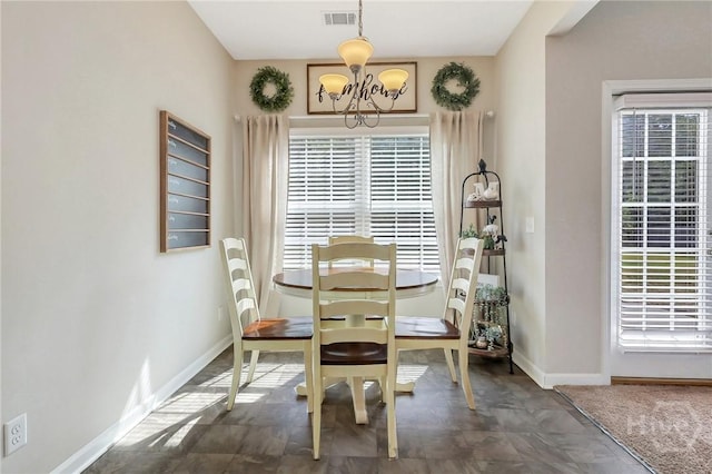 374 Bobwhite Trl NE, Ludowici, GA 31316 - dining space featuring a chandelier, plenty of natural light, and baseboards
