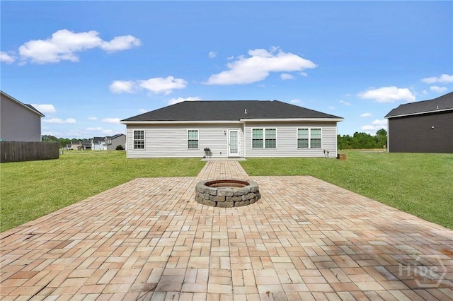 374 Bobwhite Trl NE, Ludowici, GA 31316 - back of property with a patio area, an outdoor fire pit, and a lawn