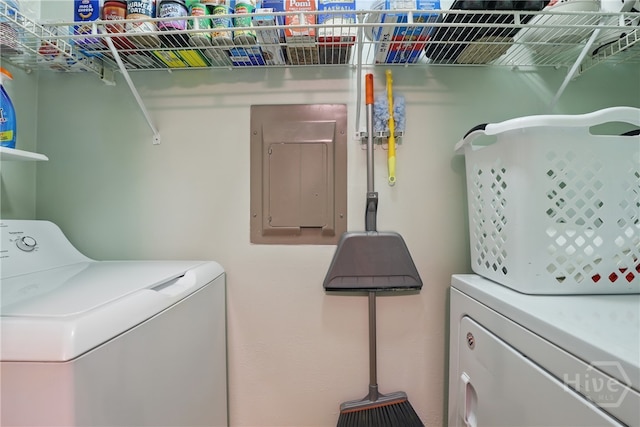 laundry area with washing machine and clothes dryer and electric panel