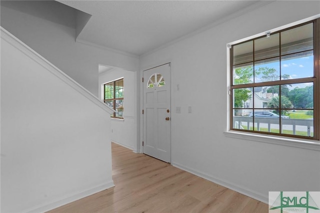 539 Pointe S Dr, Savannah, GA 31410 - entryway with light wood-style flooring, ornamental molding, baseboards, and stairway