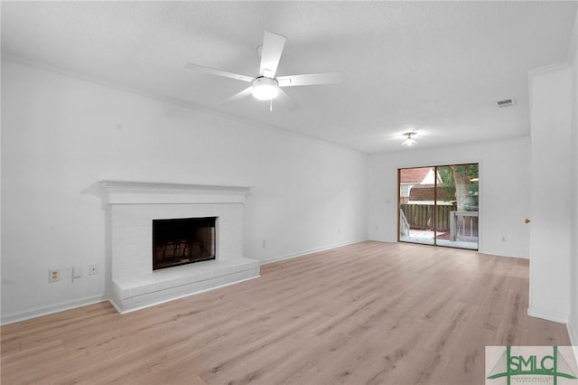539 Pointe S Dr, Savannah, GA 31410 - unfurnished living room with light wood-type flooring, a brick fireplace, ceiling fan, and baseboards