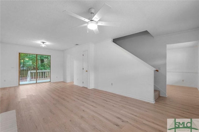 539 Pointe S Dr, Savannah, GA 31410 - unfurnished living room with light wood-type flooring, stairs, a ceiling fan, and baseboards