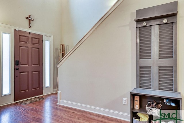 foyer with wood finished floors and baseboards