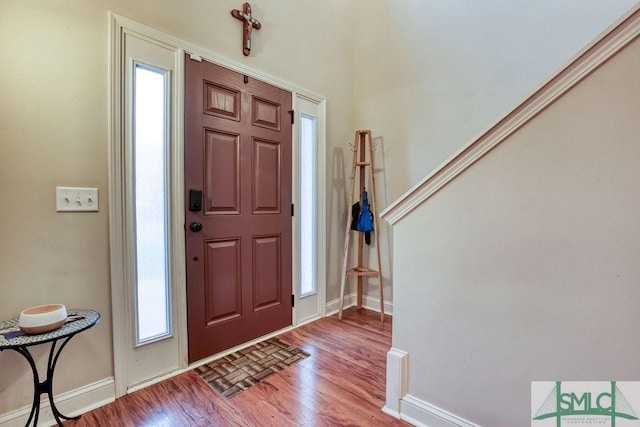 entrance foyer with wood finished floors and baseboards