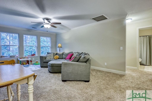 living room with a ceiling fan, ornamental molding, carpet floors, and baseboards