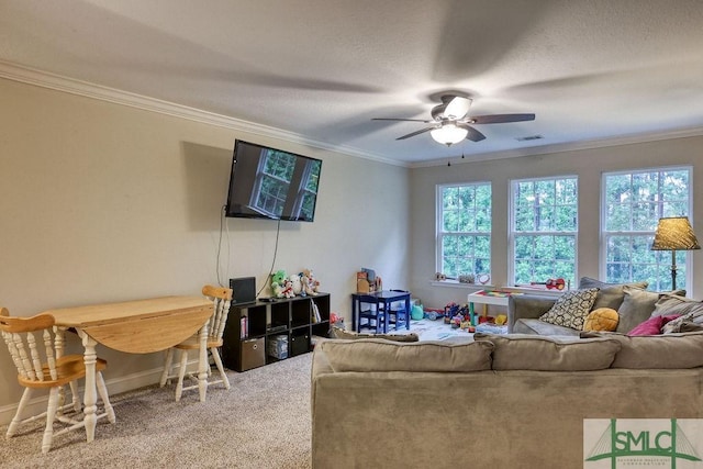 living room with crown molding, carpet floors, ceiling fan, and baseboards