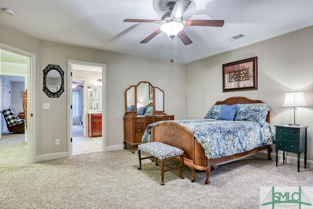 bedroom with carpet floors, baseboards, connected bathroom, and a ceiling fan