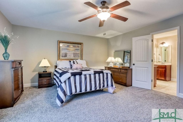 bedroom with light carpet, baseboards, and connected bathroom
