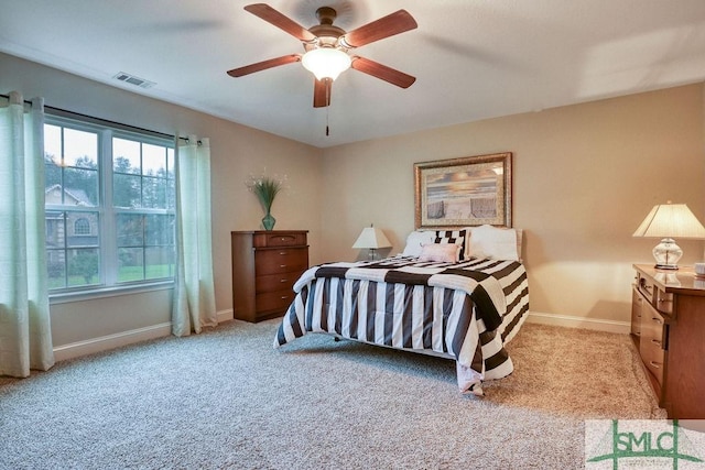 carpeted bedroom with multiple windows, baseboards, and ceiling fan