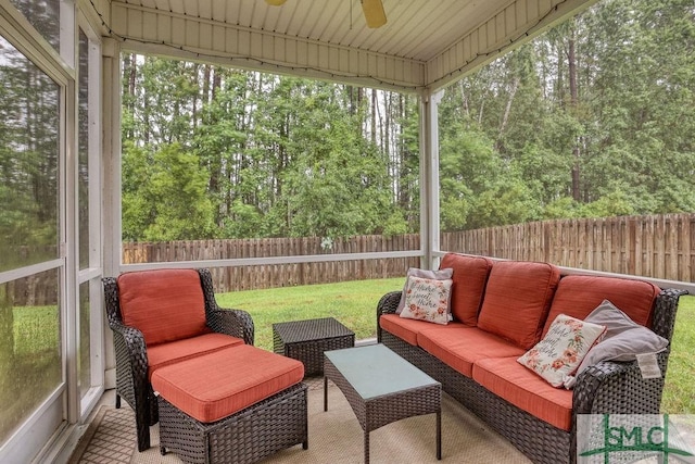 sunroom featuring ceiling fan and an outdoor living space