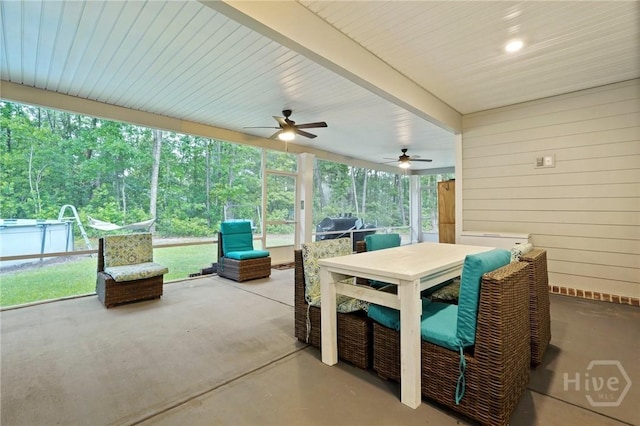 view of patio with a ceiling fan and outdoor dining area